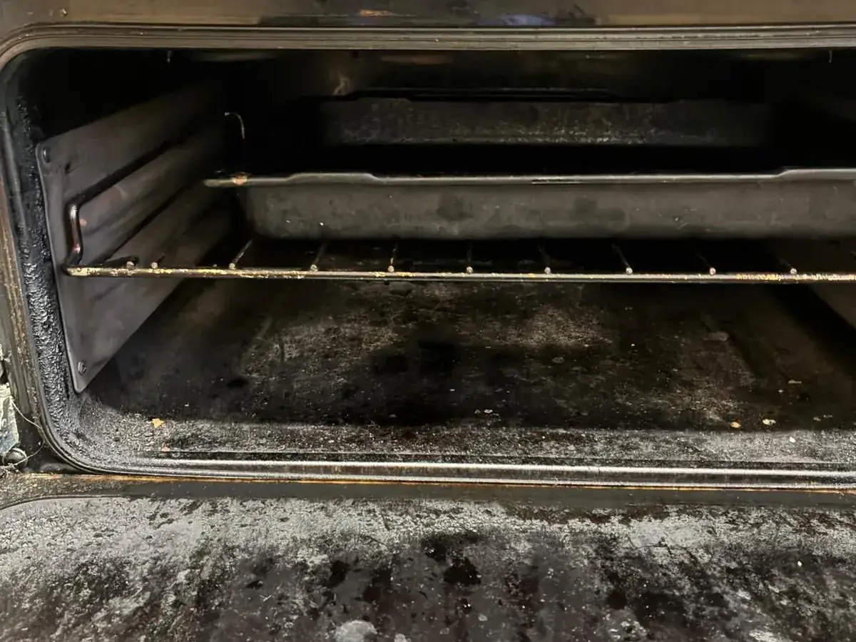 Before: Oven interior — burnt-on grease and carbon removed, racks and glass done