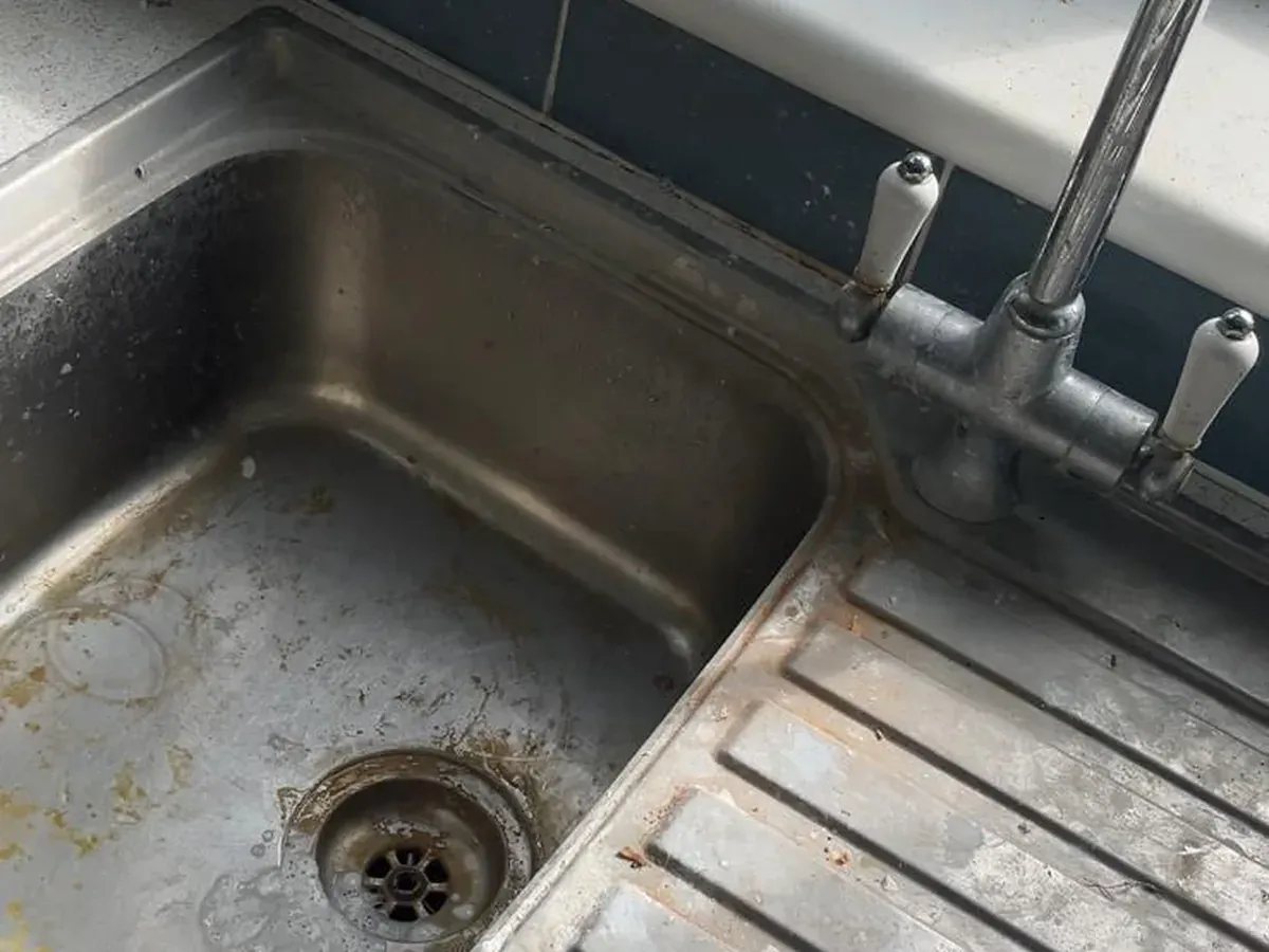 Before: Kitchen sink and drainer — limescale, rust marks and grime cleared